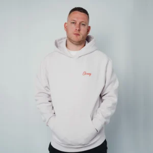 Männliches Model trägt den Mo-Torres Oversized Hoodie rosa grau, Vorderseite